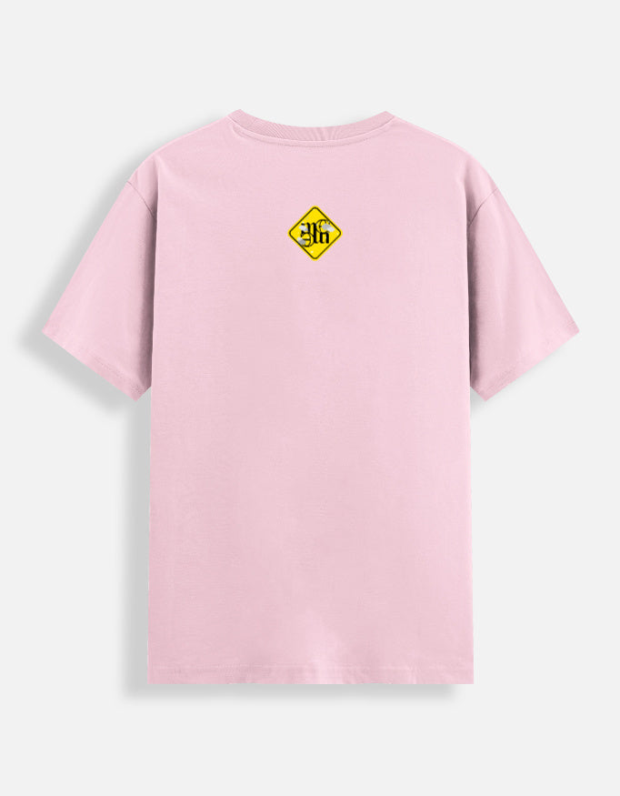 Baby pink moonearth t-shirt with a yellow and black logo on the back against a light gray background