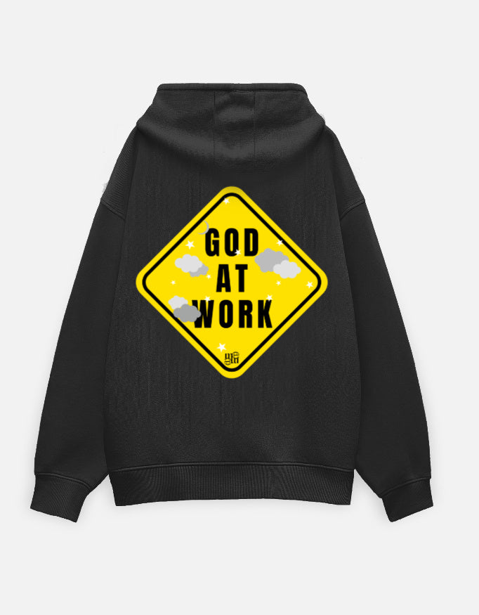 Black moonearth hoodie with a yellow 'God at Work' sign graphic on the back against a light gray background